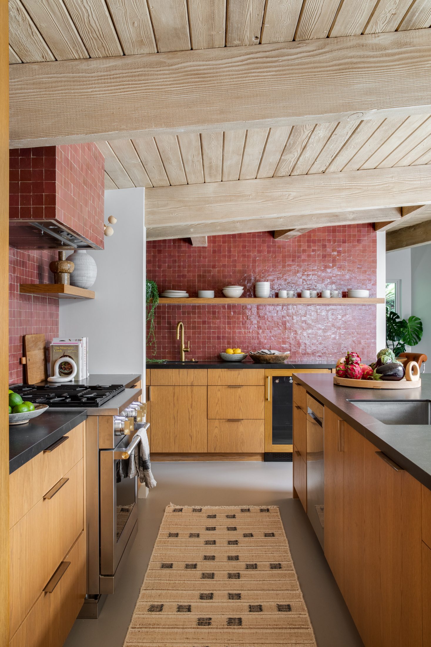 Galley kitchen with white oak cabinetry and rose-toned tile